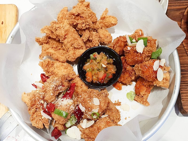 close-up platter of three double-fried Korean chicken varieties (plain, spicy, garlic-almond) filling the frame â Chir Chir Burwood, Burwood