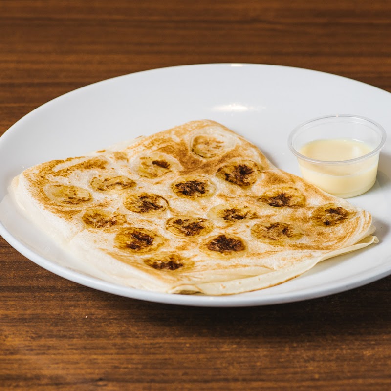 folded flaky roti (banana roti) with a cup of condensed milk for dipping â Mamak Melbourne CBD, Melbourne CBD
