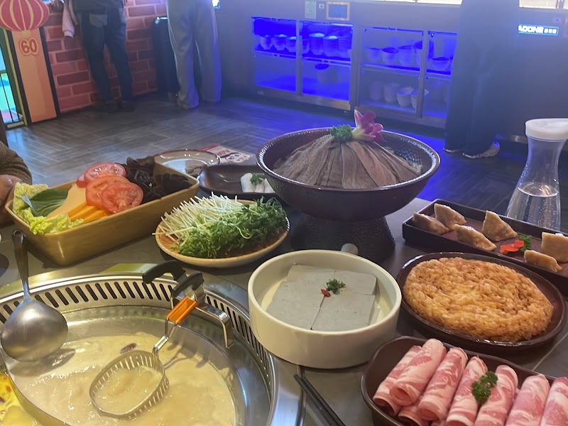 hotpot broth pot on the table surrounded by raw sliced meat, tofu, greens and other ingredients ready to cook â Panda Hot Pot Box Hill, Box Hill