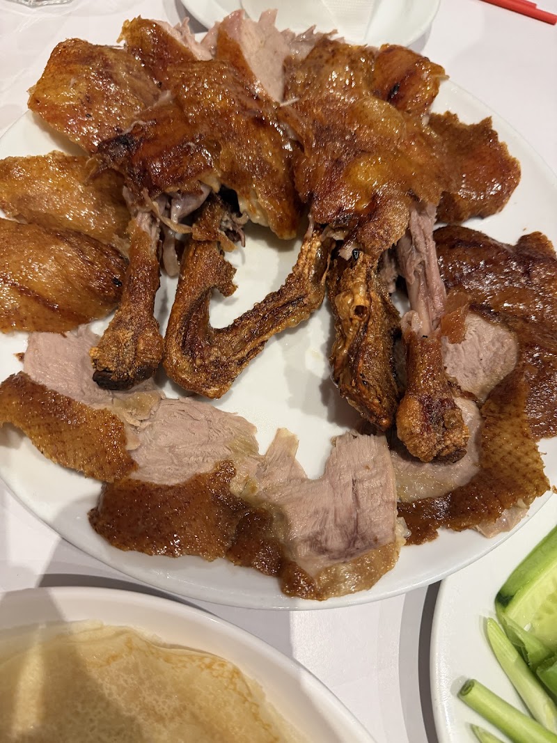 close-up of carved peking duck slices with crispy skin, pancakes and spring onion visible â Simon's Peiking Duck, Box Hill South