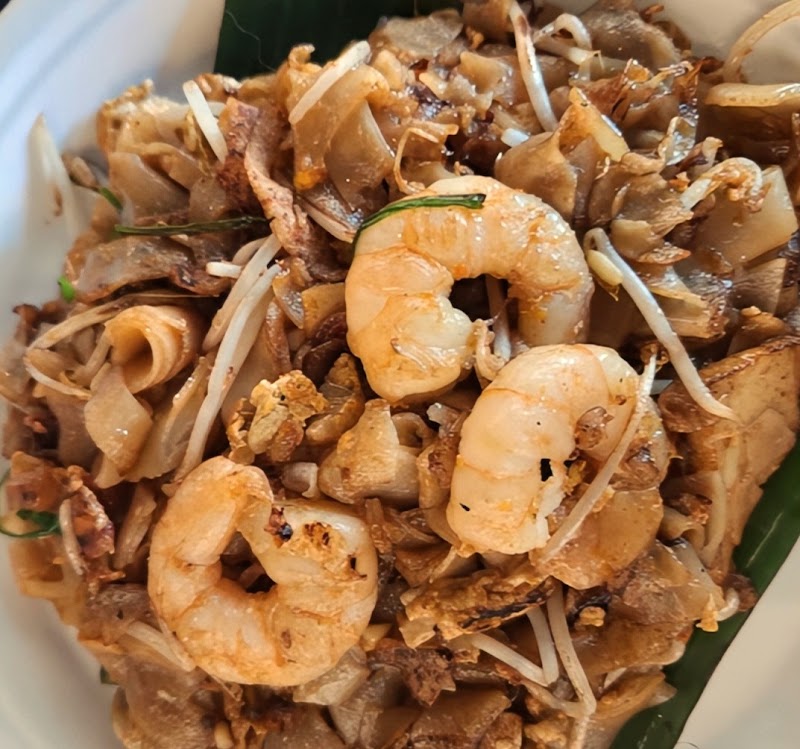 close-up filling the frame of dark caramelized flat rice noodles stir-fried with prawns and bean sprouts â Tasty Of Penang, Burwood