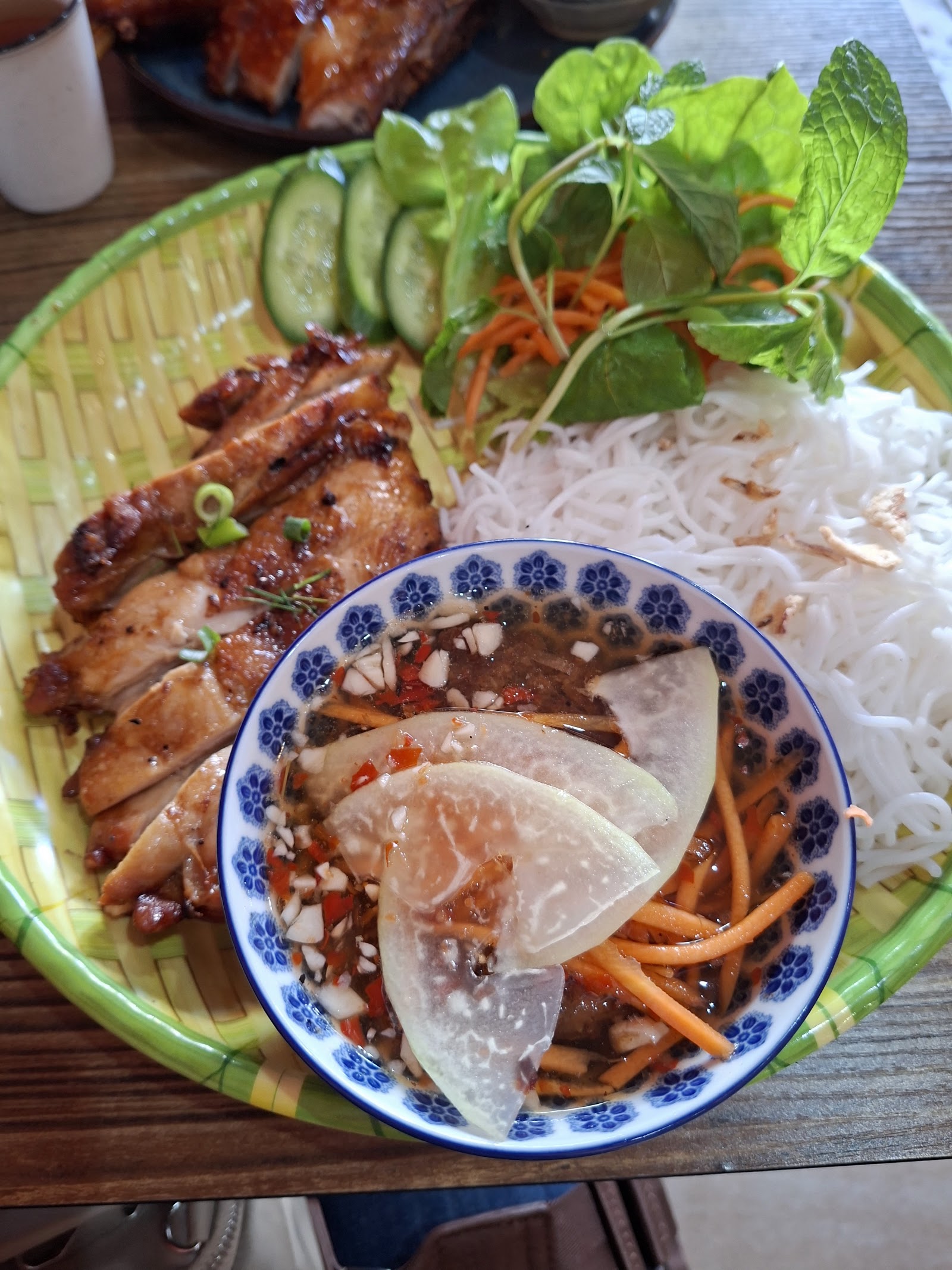 sliced grilled chicken with bun, herbs, cucumber and a bowl of nuoc cham with pickled green papaya â Vietfull Vietnamese Street Foods, Marrickville