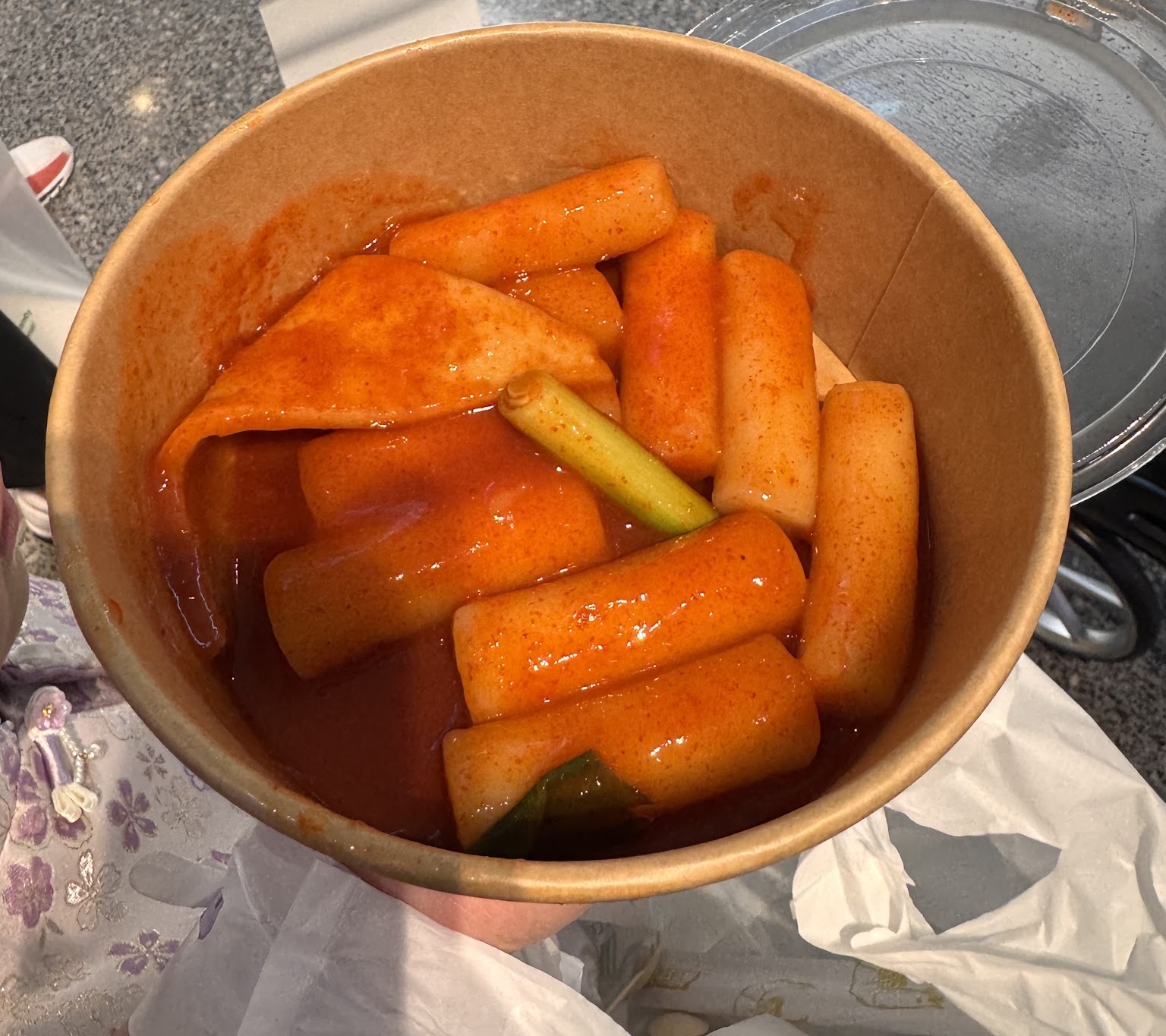 cylindrical rice cakes and fish cake sheets in glossy gochujang sauce; cropped to the bowl â Bunsik Parramatta, Parramatta